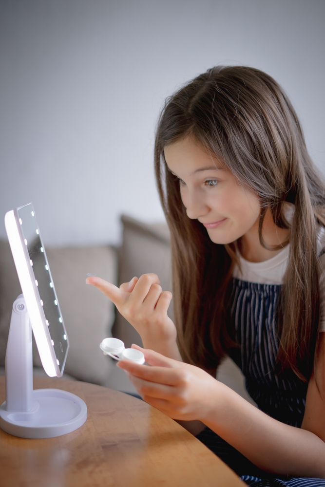 Woman holding contact lenses - Specialty Contact Lenses in Carrboro, NC